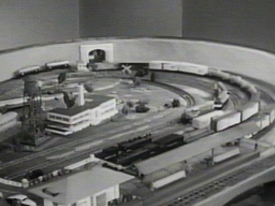 Industrial Area with 1 Factory This view of the industrial area appears in the introductory portion of each episode of the Boys' Railroad Club. The second factory has not yet been placed on the layout, but it appears by the 5th episode.