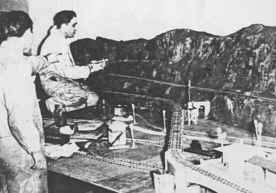 Unidentified Worker & Frank Castiglione Working On Mountain Based on the type of work Frank Castiglione did on the layout, I would surmise that he is the one touching up the mountain. I'm not sure who the other worker is.