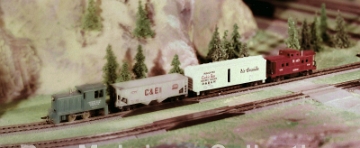 HO Industrial Switcher Set This photo may have been taken on the 200 5th Avenue layout. We can probably date this photo to 1959 or possibly 1960 as it shows the Industrial Switcher HO set offered in those years. I suspect these photos are from 1959, rather than 1960 as the collection of photos omits the C&O Alco DL-600 set offered in 1960, but not in 1959. The only photo I have seen that shows that entire 200 5th Avenue layout appears to have an elevated area for HO and that is where I think this photo might have been taken. I have not been able to identify any Gilbert advertising which uses this photo.