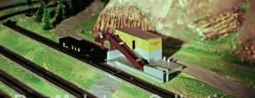 HO Drum Loader This photo may have been taken on the 200 5th Avenue layout. We can probably date this photo to 1959 or possibly 1960 as it shows Drum Loader first offered in 1959. Also arguing in favor of a 1959 date is that fact that the accessory pictured is a prototype version, not the version as actually manufactured. The only photo I have seen that shows that entire 200 5th Avenue layout appears to have an elevated area for HO and that is where I think this photo might have been taken.