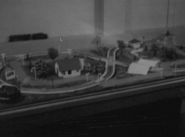 It may be that the track is mounted on a sub roadbed which is separate from the panels and can either sit on the panel or be elevated in certain portions, as would be the case with the figure eight.