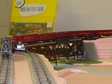 Heavyweight passenger train heading across the trestle.